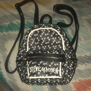 Mini Steve Madden backpack with flower decor.